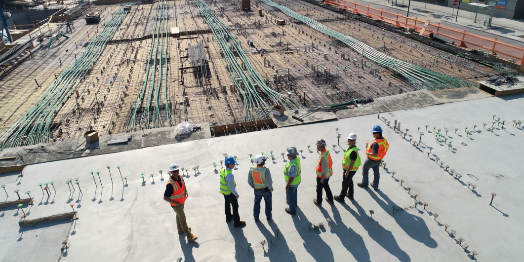 Construction workers on top of a building