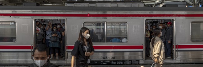 MORNING COMMUTERS ON THE PLATFORM AT MANGGARAI TRAIN STATION IN JAKARTA, INDONESIA.