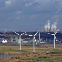 wind turbines behind a marsh
